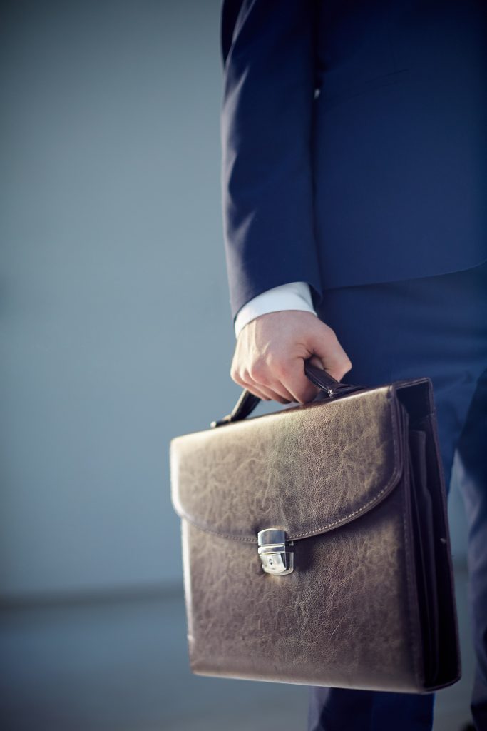 close-up-businessman-holding-briefcase